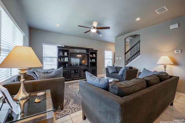 tiled living room featuring ceiling fan