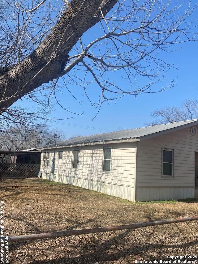 view of side of home with a lawn