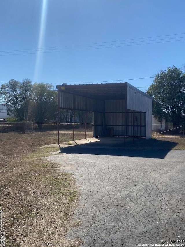 view of pole building featuring a carport and aphalt driveway