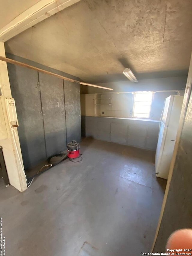 basement with freestanding refrigerator