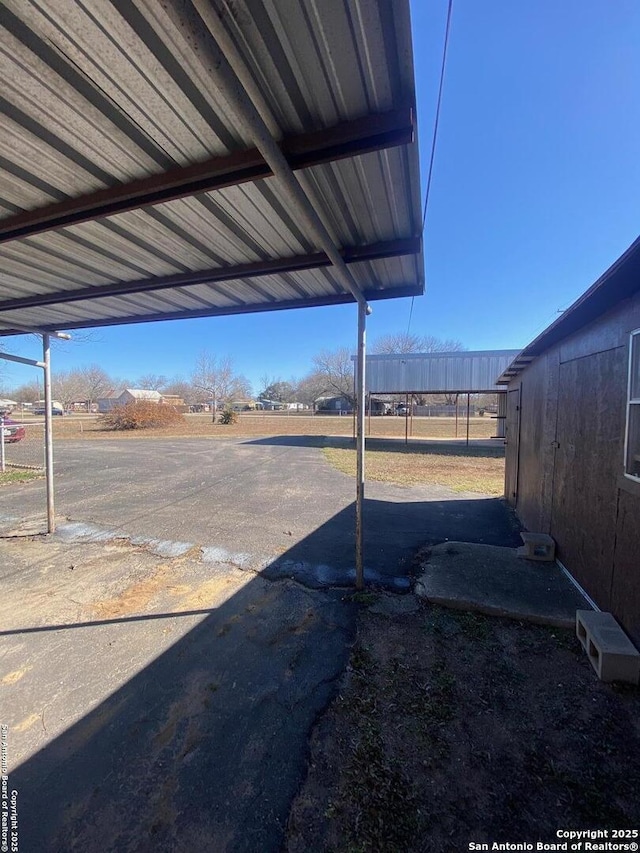 view of yard featuring a carport and fence