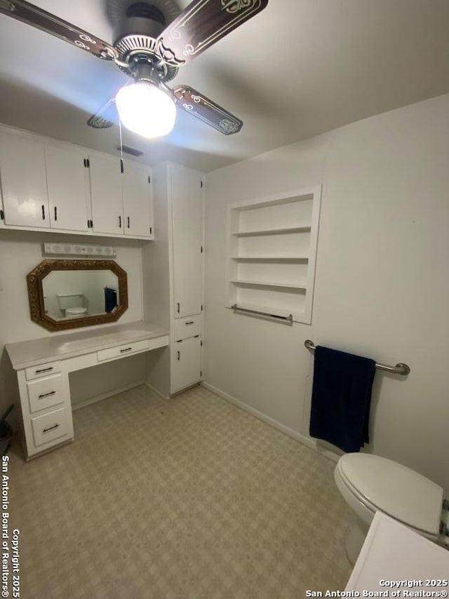 office area featuring ceiling fan, built in shelves, and baseboards