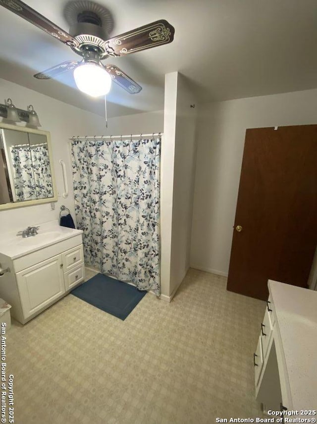 bathroom featuring ceiling fan, a shower with shower curtain, vanity, baseboards, and tile patterned floors