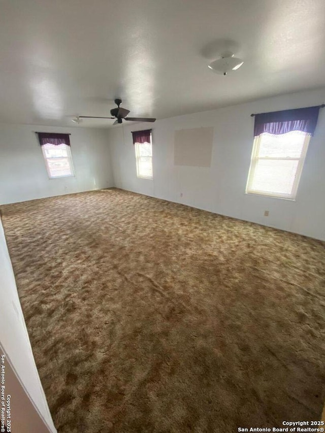 carpeted empty room with ceiling fan