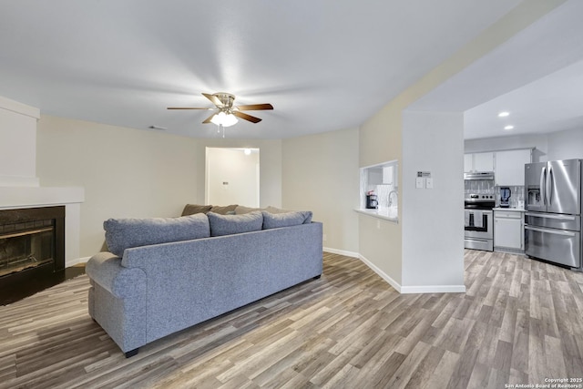 8907 Athens, San Antonio, TX 78251 - living room with ceiling fan and light hardwood / wood-style floors