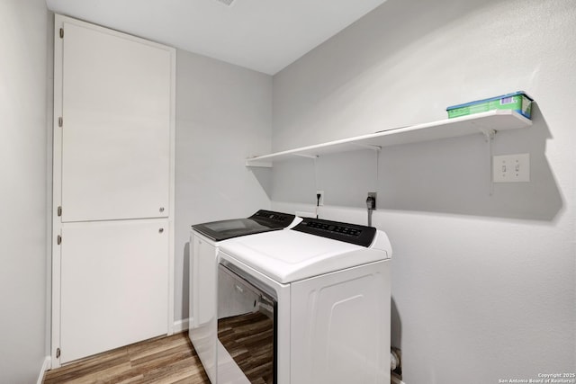 8907 Athens, San Antonio, TX 78251 - washroom featuring washer and dryer and light hardwood / wood-style floors