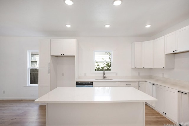 1645 W Magnolia Ave, San Antonio, TX 78201 - kitchen featuring a sink, a kitchen island, white cabinets, light wood-type flooring, and dishwashing machine
