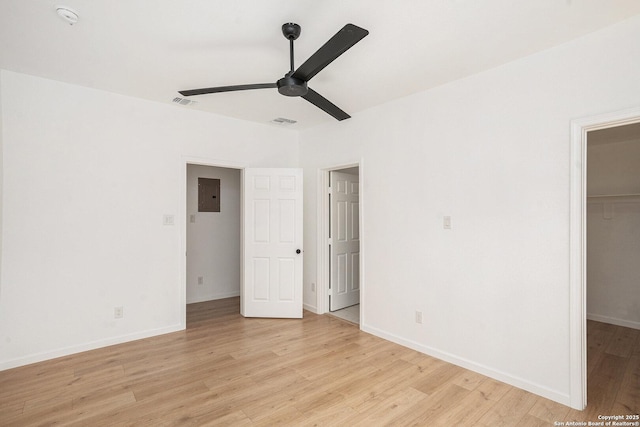 1645 W Magnolia Ave, San Antonio, TX 78201 - unfurnished bedroom with a walk in closet, electric panel, light wood finished floors, a closet, and baseboards