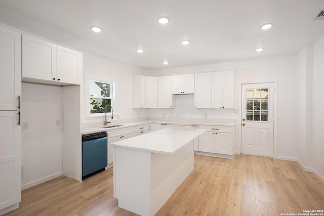 1645 W Magnolia Ave, San Antonio, TX 78201 - kitchen with dishwashing machine, a sink, light wood-style flooring, healthy amount of natural light, and recessed lighting