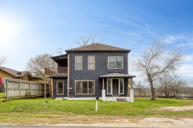 view of front of home with a front lawn and a balcony