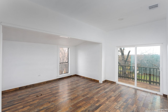 unfurnished room with a wealth of natural light and dark wood-type flooring