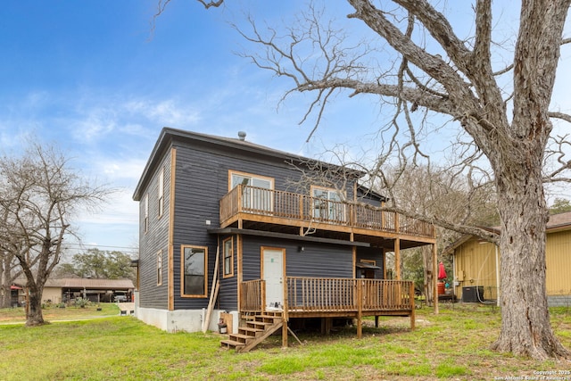 back of house with a deck, central AC unit, and a yard