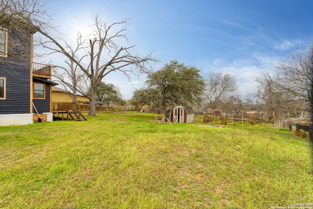 view of yard featuring a shed and a wooden deck