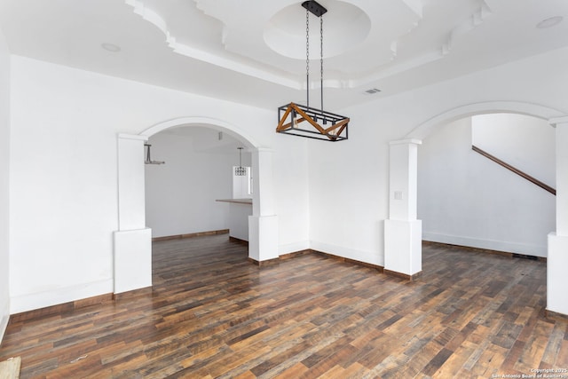 interior space featuring dark hardwood / wood-style flooring and a raised ceiling