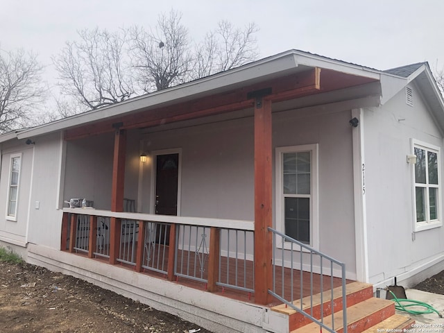 view of side of property with covered porch