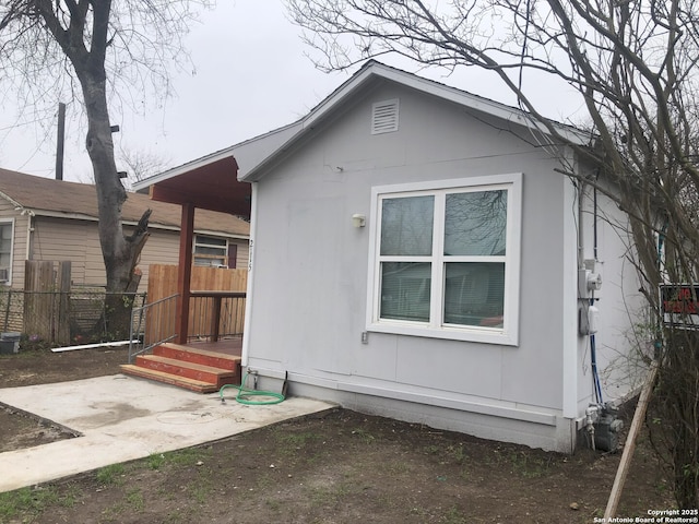 view of side of property with a patio