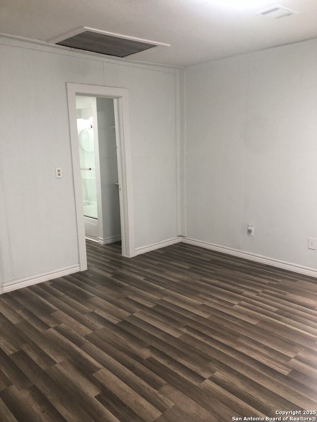 unfurnished room with dark wood-type flooring