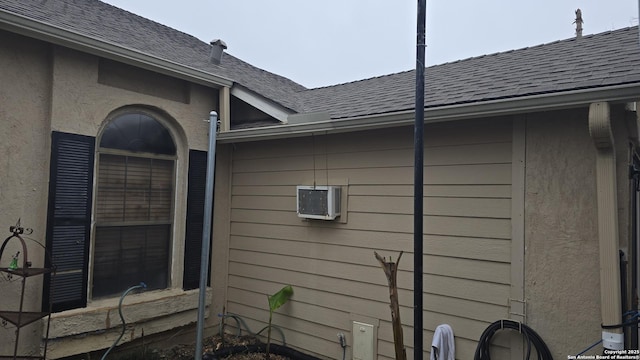 view of side of property with a shingled roof