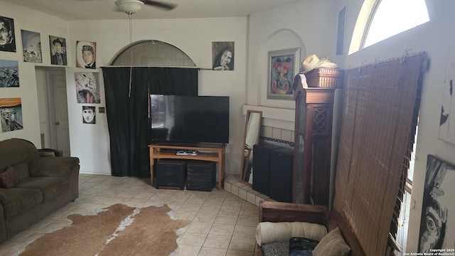 living room with light tile patterned floors and a ceiling fan