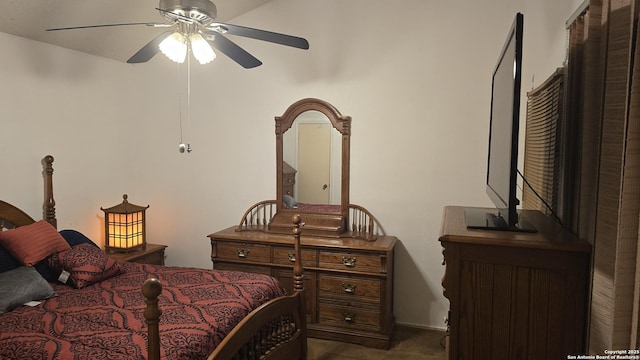 bedroom featuring ceiling fan and dark carpet