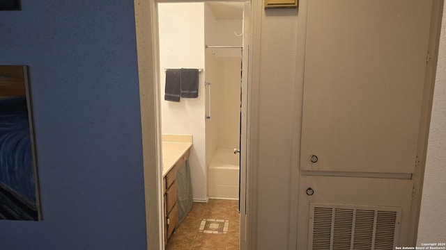 full bathroom featuring tile patterned flooring, vanity, and bathing tub / shower combination