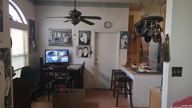 dining area featuring a ceiling fan and light tile patterned flooring