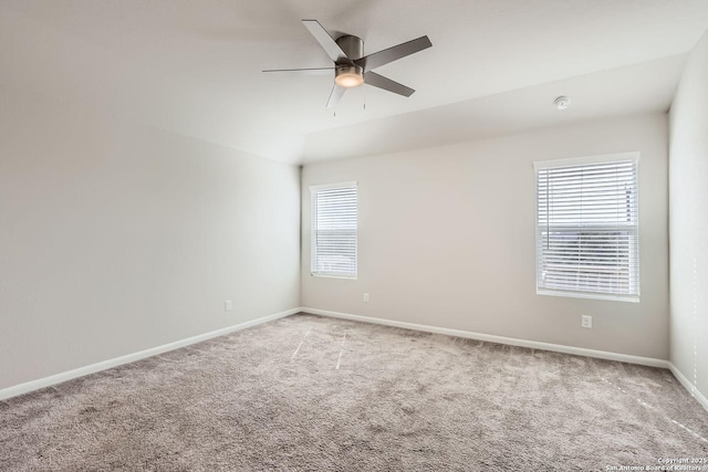 spare room with ceiling fan, carpet floors, and baseboards