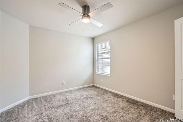 empty room with carpet floors, baseboards, and a ceiling fan