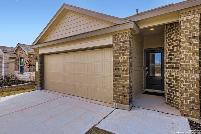 exterior space featuring brick siding, driveway, and an attached garage