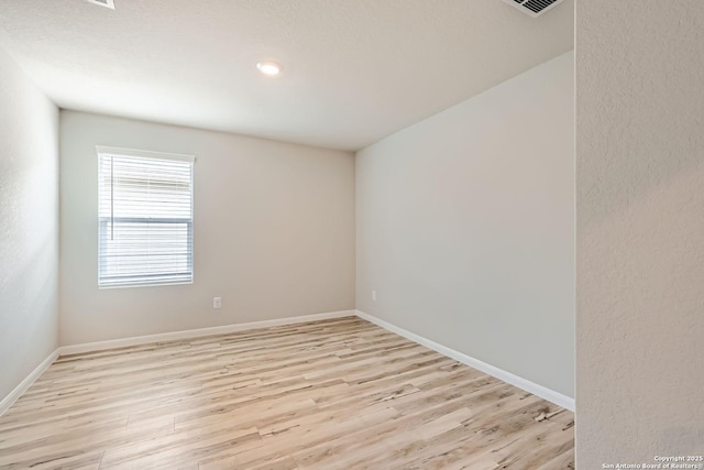 unfurnished room featuring light wood-style flooring and baseboards