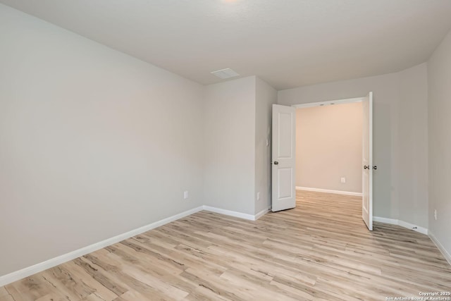 unfurnished room featuring light wood finished floors and baseboards