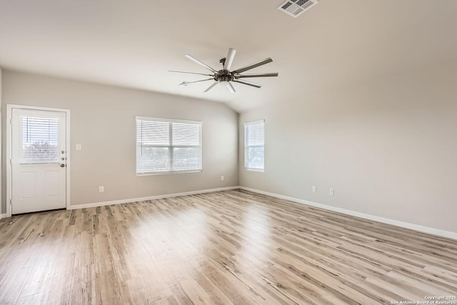 empty room featuring light wood finished floors, a ceiling fan, visible vents, and baseboards