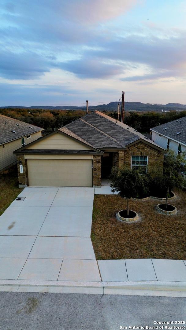 ranch-style house with a garage and concrete driveway