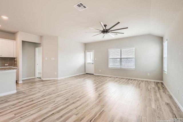 unfurnished living room featuring ceiling fan, light wood-style flooring, visible vents, and baseboards