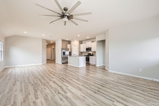 unfurnished living room featuring baseboards, light wood finished floors, visible vents, and a ceiling fan