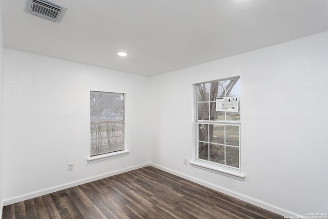 spare room with dark wood-type flooring