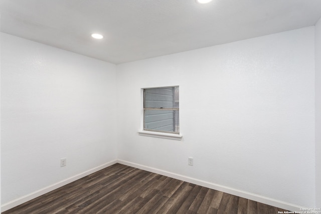 empty room with dark wood-type flooring