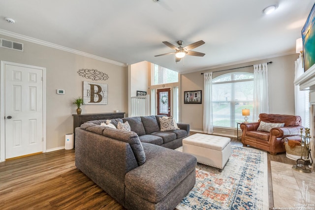 living room featuring ceiling fan, hardwood / wood-style flooring, and crown molding