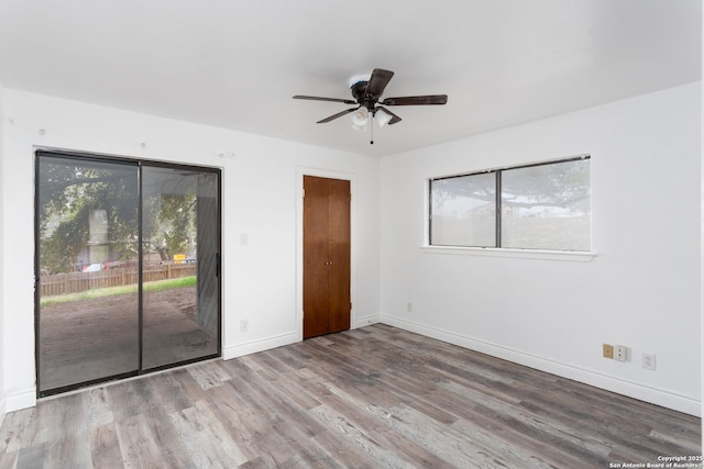 unfurnished bedroom featuring light hardwood / wood-style floors, ceiling fan, and access to exterior