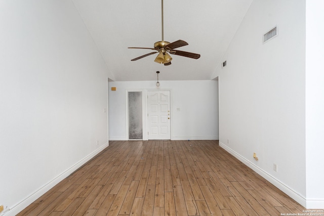 spare room with light hardwood / wood-style floors, high vaulted ceiling, and ceiling fan