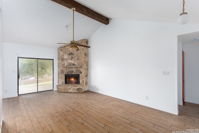 unfurnished living room featuring high vaulted ceiling, light hardwood / wood-style floors, ceiling fan, a fireplace, and beamed ceiling