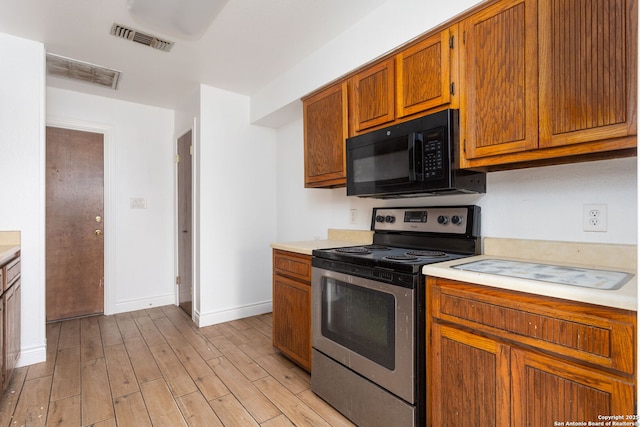 kitchen featuring stainless steel range with electric stovetop and light hardwood / wood-style floors