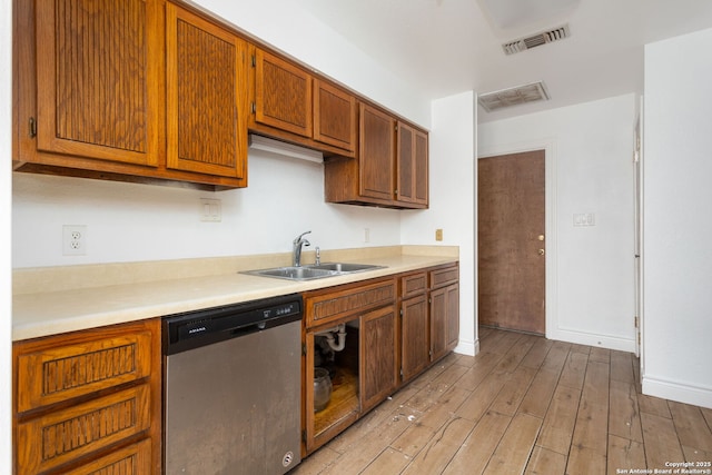 kitchen featuring light wood-type flooring, sink, and stainless steel dishwasher