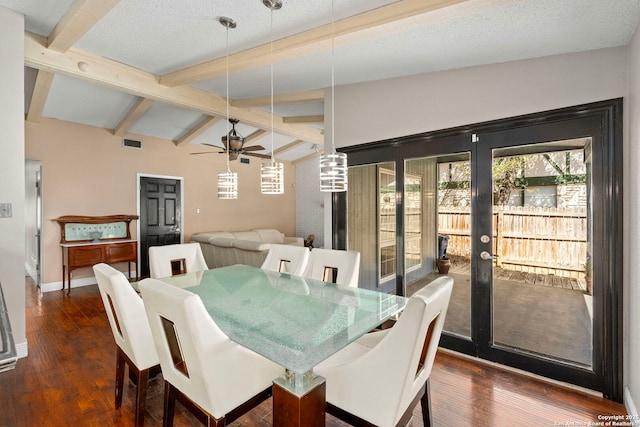 dining room featuring visible vents, lofted ceiling with beams, dark wood finished floors, baseboards, and ceiling fan