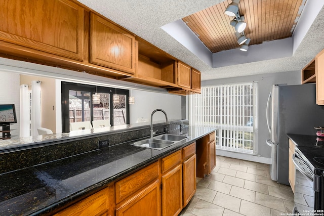 kitchen with brown cabinets, a sink, open shelves, a raised ceiling, and wood ceiling