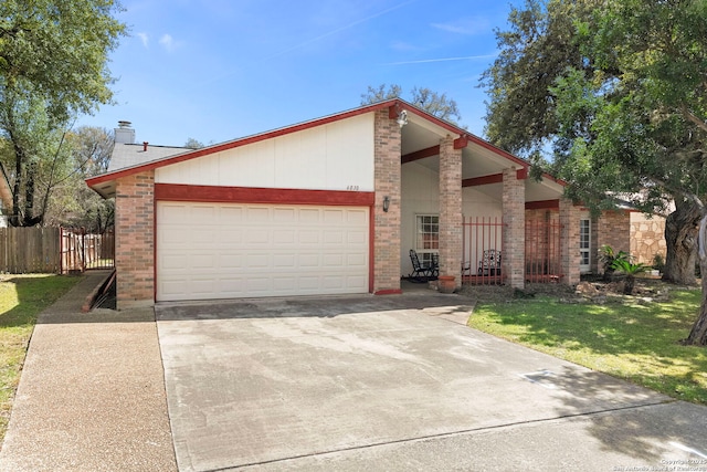 mid-century home with fence, a chimney, concrete driveway, a front lawn, and a garage