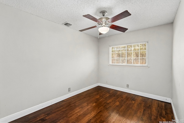 spare room featuring visible vents, a ceiling fan, a textured ceiling, wood-type flooring, and baseboards