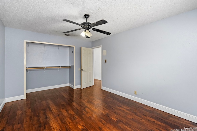 unfurnished bedroom featuring a closet, a textured ceiling, baseboards, and hardwood / wood-style floors