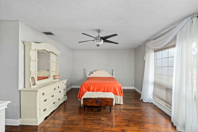 bedroom with visible vents, baseboards, a ceiling fan, and wood finished floors