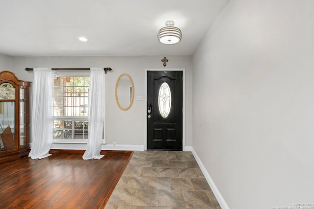 foyer entrance featuring recessed lighting, baseboards, and wood finished floors